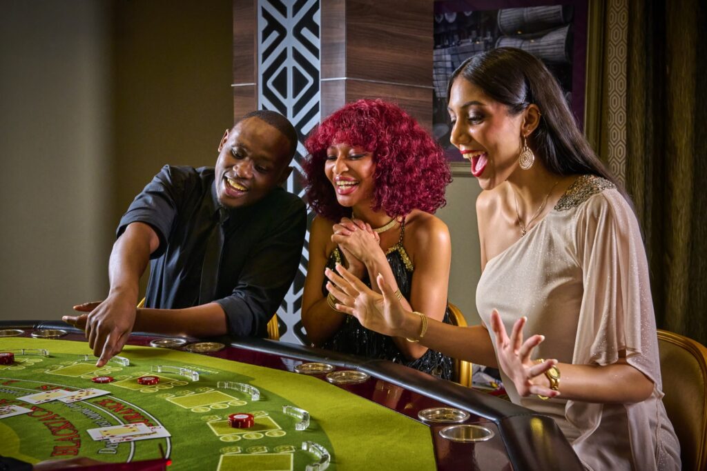 Players celebrating at a blackjack table in the casino at Metcourt Umfolozi